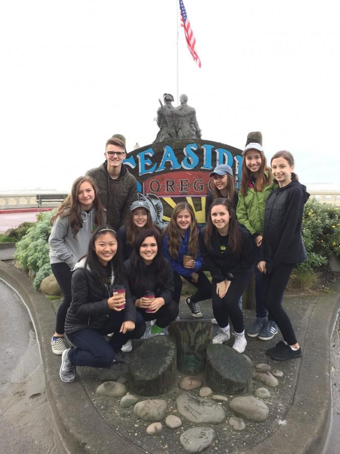 Members of the freshman class cabinet pose in front of the Seaside sign during a weekend getaway at the beach in order to improve their leadership skills. Photo by passerby.
