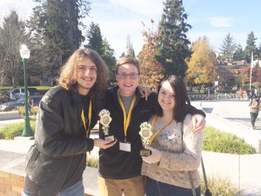 Clarion reporter Bart Brewer (left) along with Editors-in-Chief Conor Bergin (center) and Ashley Lytle (right) pose with their newly received trophies.