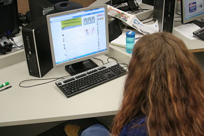 A student reads the growing comment thread on a Facebook post.