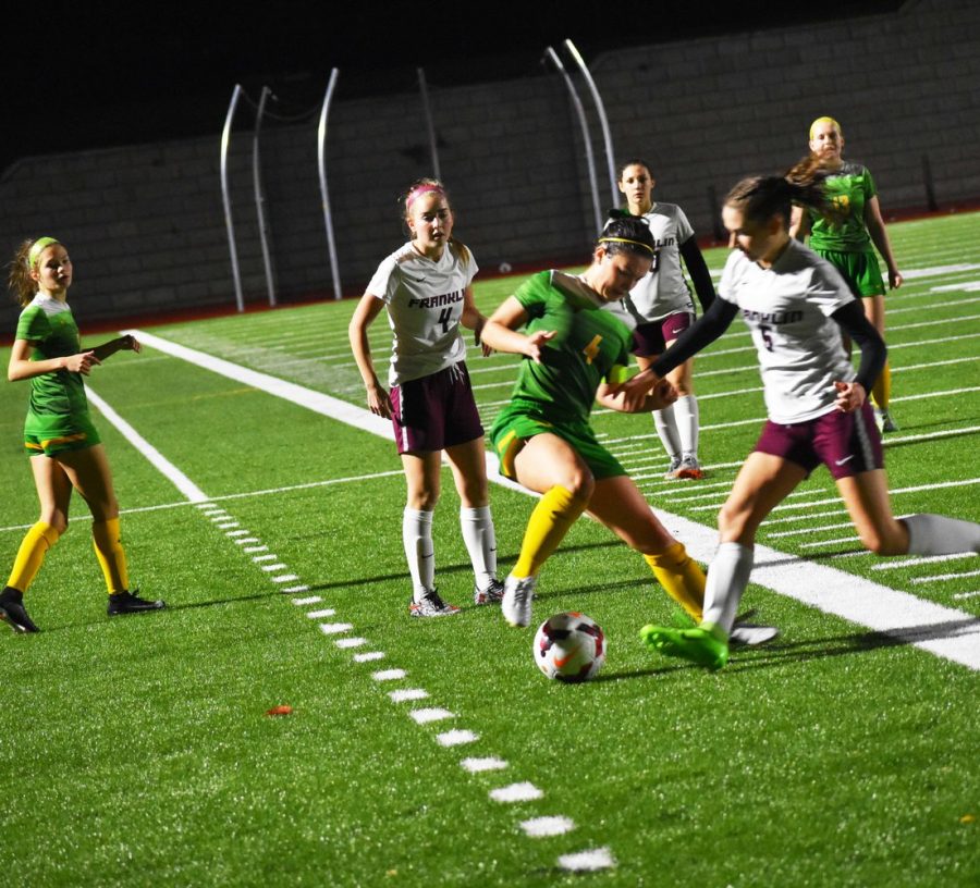 Senior Lauryn Ruegg maintains control of the ball in the final league match of the regular season Oct. 19 against Franklin. The Warriors won 7-0 and completed an undefeated regular season and first place finish in the Portland Interscholastic League.