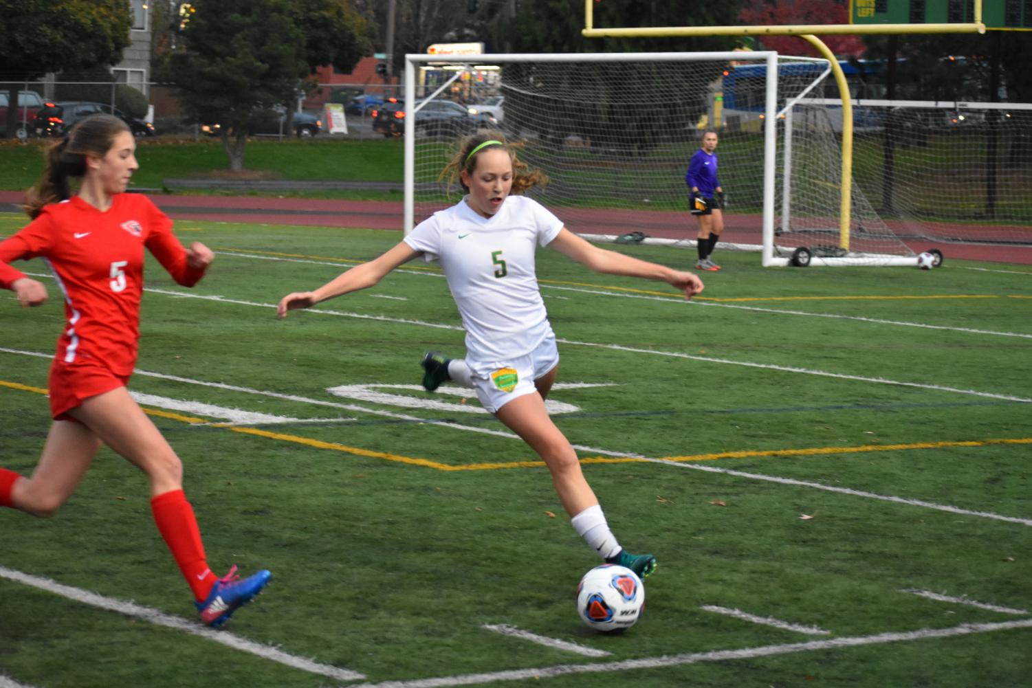 Devon Burke, freshman, clears the ball in the first half of the quarterfinal game against Lincoln on Nov. 4.
