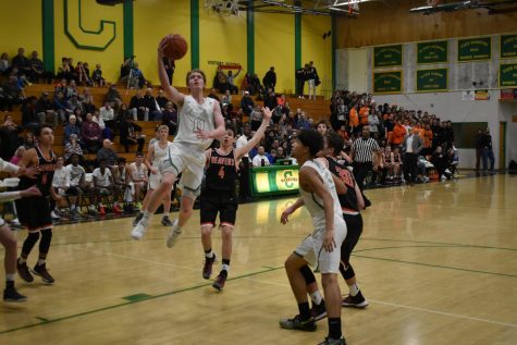 Rowan Anderson, who scored a game-high 19 points for the Warriors,  drives to the hoop in the Warriors season-opening loss to Beaverton Dec. 1.