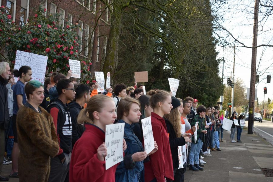 Students stand silently outside the school on March 14 for 17 minutes, honoring the 17 victims of the recent Florida school shooting and advocating for political action on ensuring safety in schools.