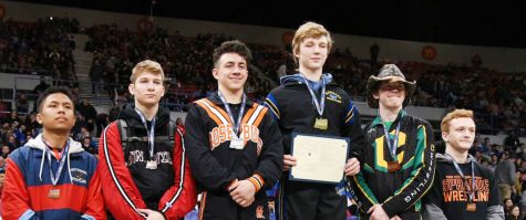 Freshman Logan Medford, second from right, takes third at the state tournament in wrestling at 126 pounds.
