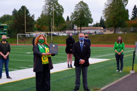 Principal JoAnn Wadkins (left) holding award plaque  just presented by Dr.James Weaver (right) of the NFHS 