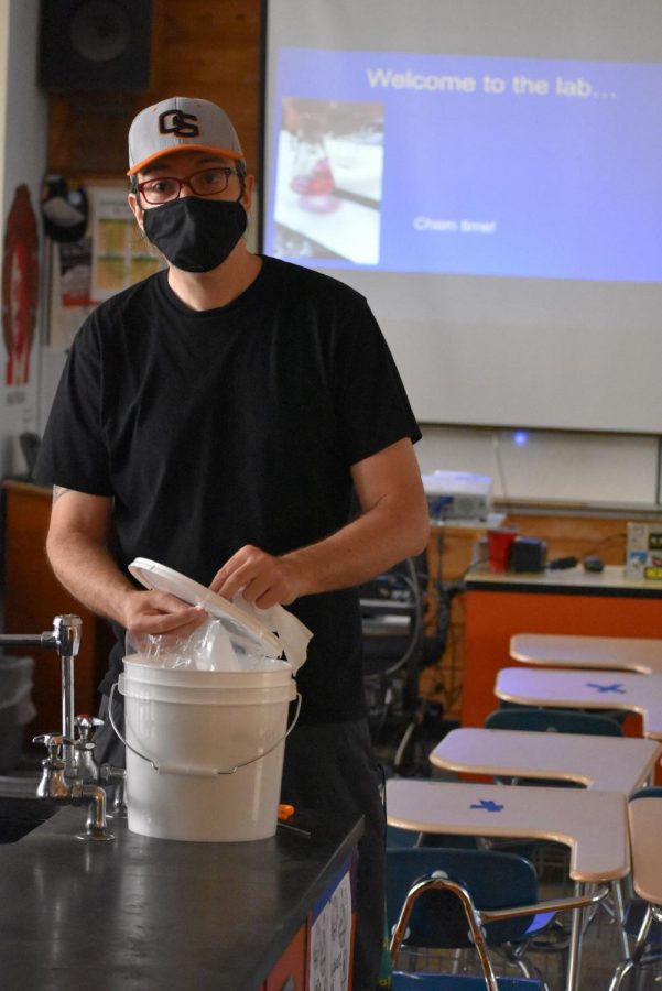 Science teacher Matt Staab preps his classroom for the first day back on in person learning.