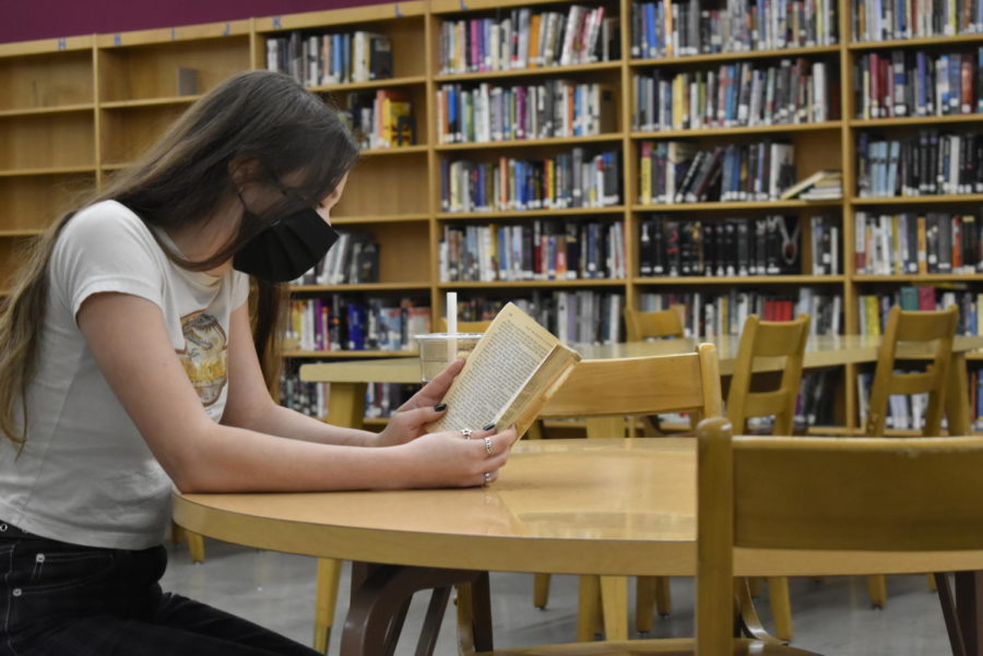 Nina Chait, senior, reads in the library, finding some quiet time during the day.
