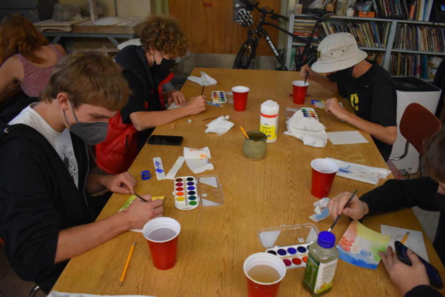 Grant Kloeppel Sophomore(Lower Left) Miles Jeffery Sophomore(Upper Left) and Cleveland Students painting in Ceramics class.