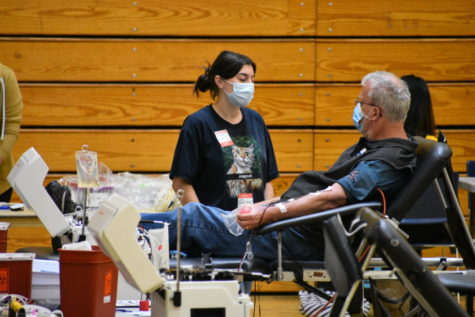 An adult volunteer gives blood at the Red Cross Blood Drive on Sept. 29.