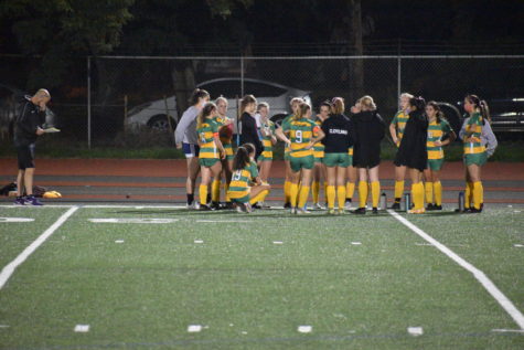 The girls soccer team huddles at halftime against Franklin, winning 1-0.