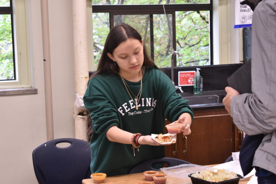 Mary Rosales prepares food for a student at the cultural fair Sept. 29 in Richard Acunas class.