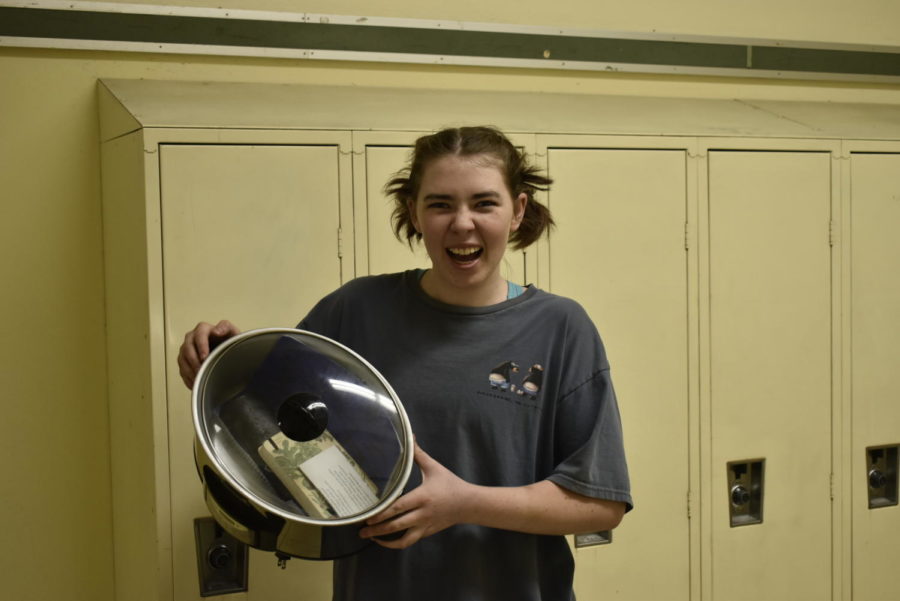 Prue Bailey, sophomore, poses for a photo with their trusty crock-pot on Anything But a Backpack Day.