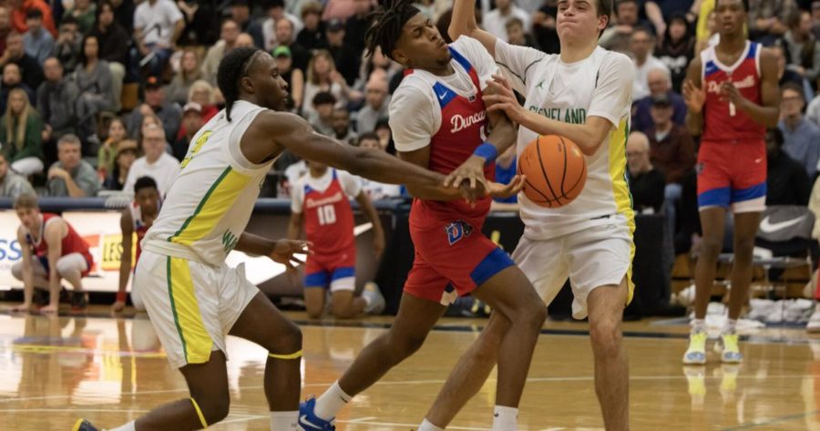 Jamel Pichon, left, and Josh Huss, right, play defense against Duncanville in the opening round of the Les Schwab Invitational.
