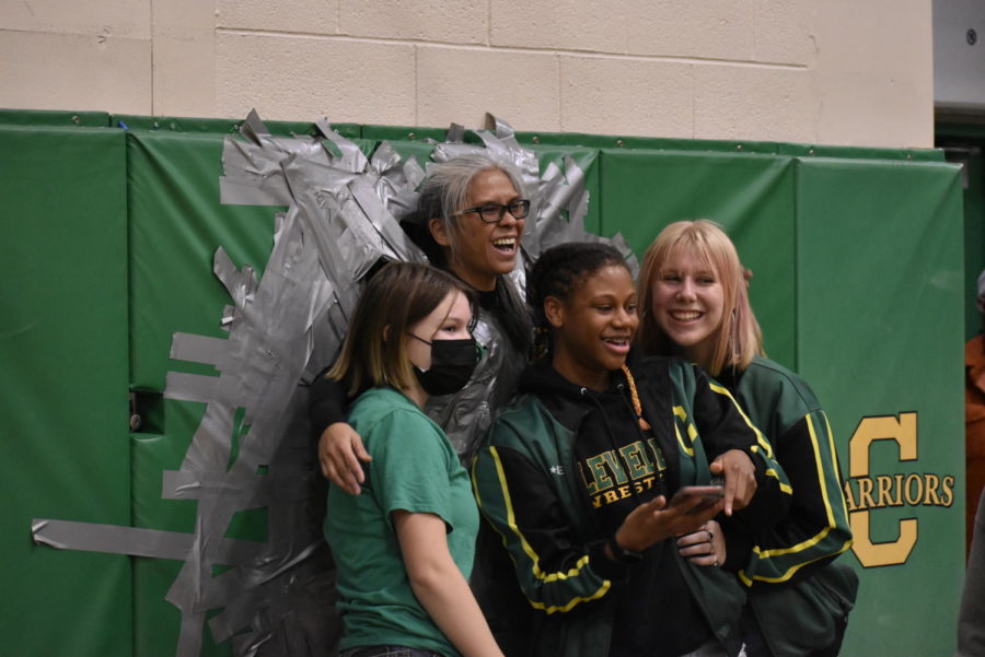 Teacher Brenda Gordon poses with students who helped tape her to the wall. Gordon agreed to be taped as an incentive for students to raise money for CHS Gives Back fundraiser.