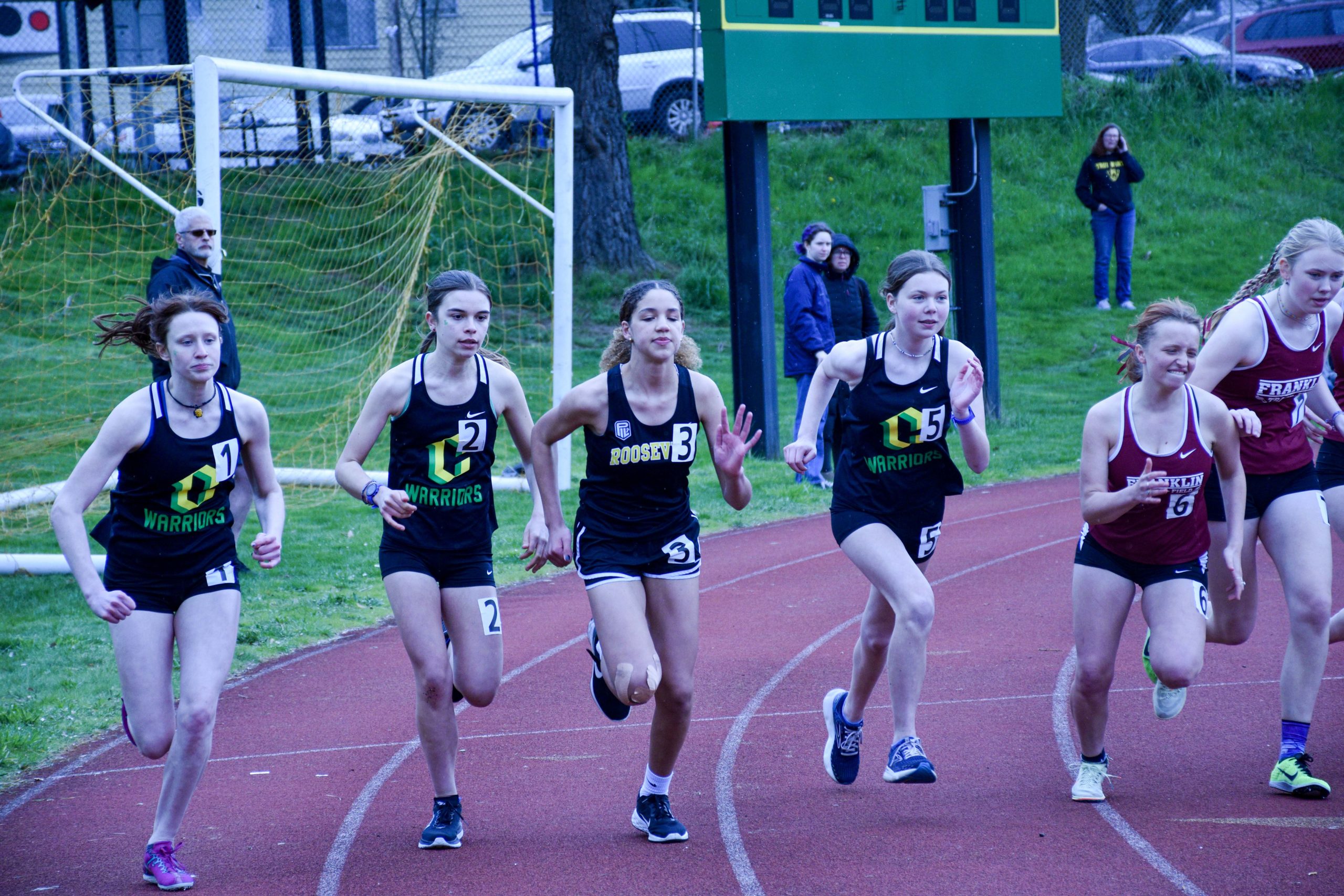 Iris Stasiuk, Cora Frick, and Anna Rogoway represent Cleveland in the 1500 meter race on April 5.