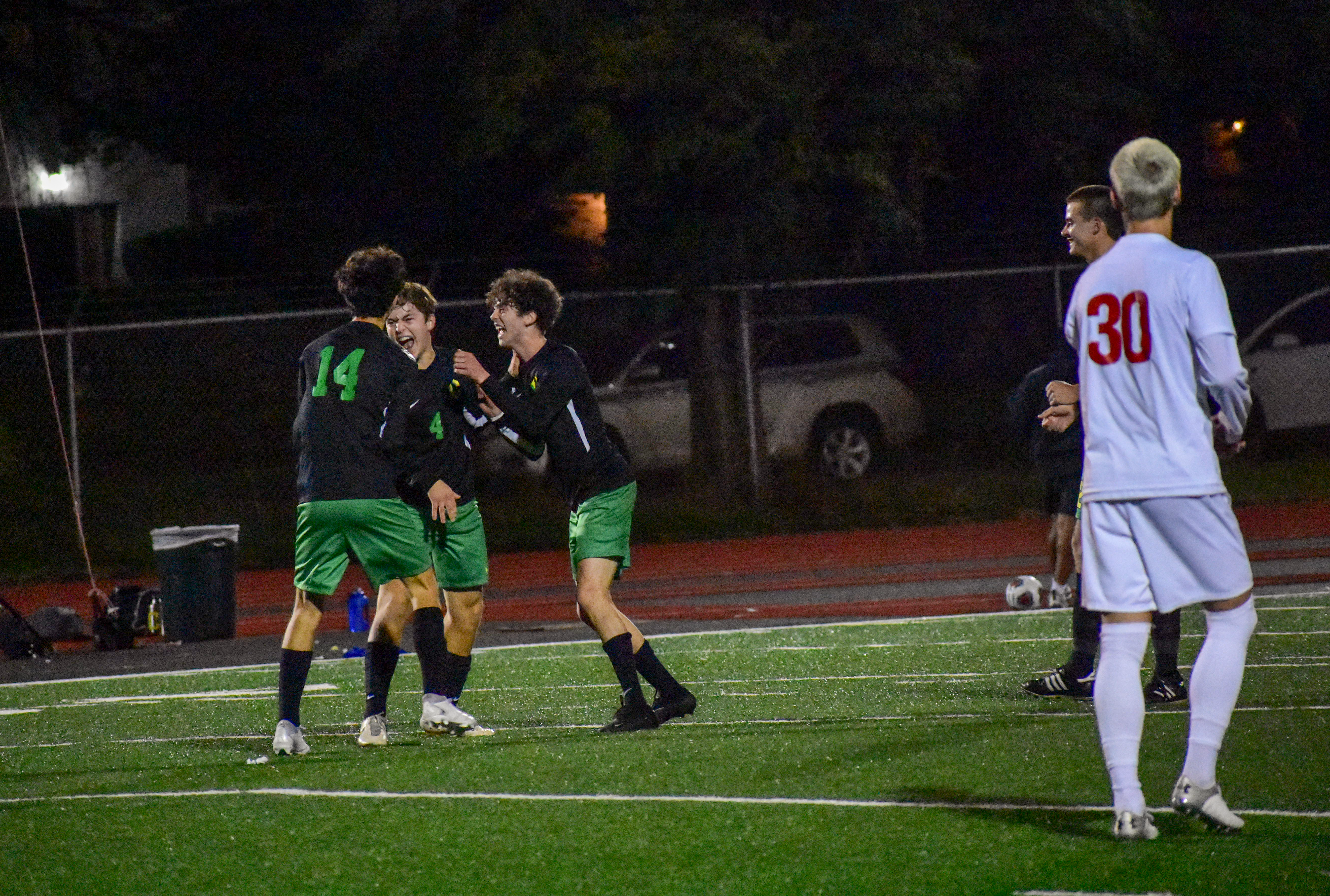 Fillipo Gallo celebrates with Rowan Symons and an unidentified player after scoring against Lincoln. The Warriors won 2-1 on Oct. 3.
