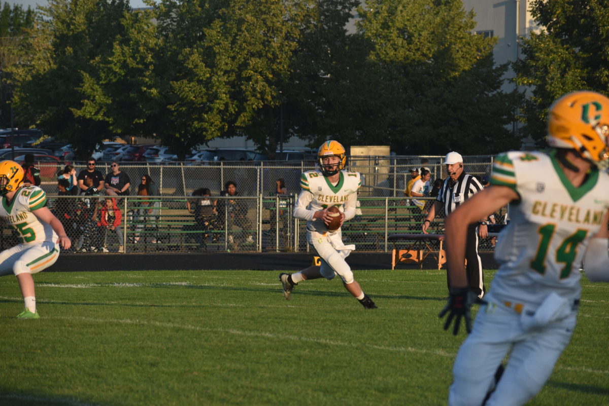 Quarterback James Ho looks downfield for options during Clevelands season opening 28-22 win against Parkrose on Sept. 1.