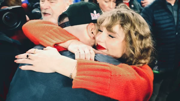 Taylor Swift hugs Travis Kelce immediately after a big win.