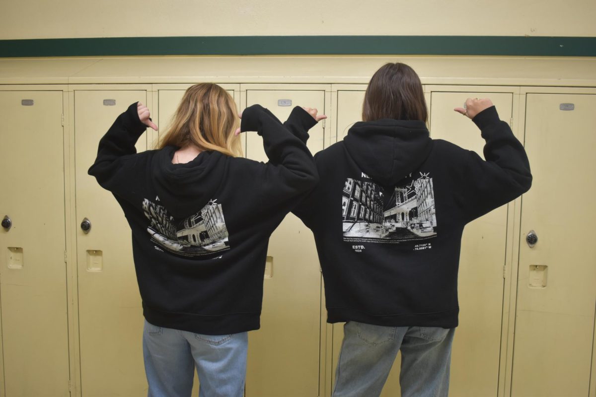 Cassandra Quirico and Gwen Van Oostrum twinning with black hoodies and blue jeans.