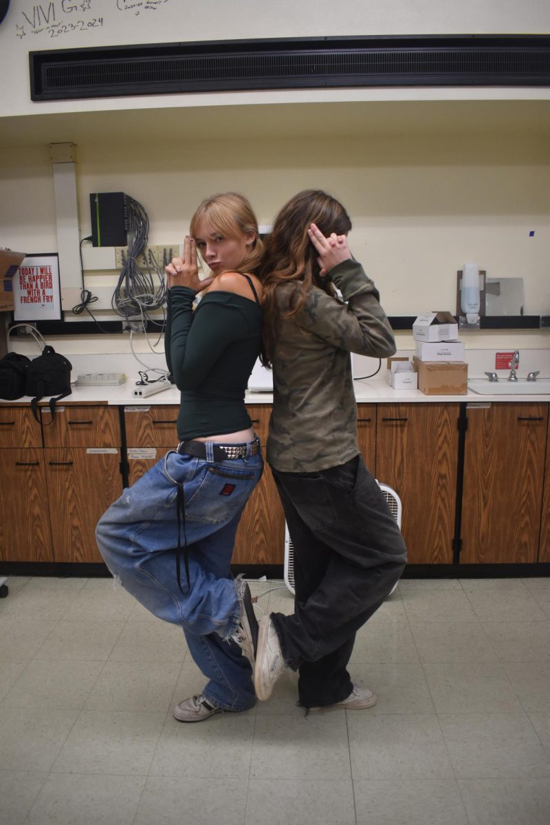 Violet Dashney and Vivienne Costa wearing greens with baggy jeans.