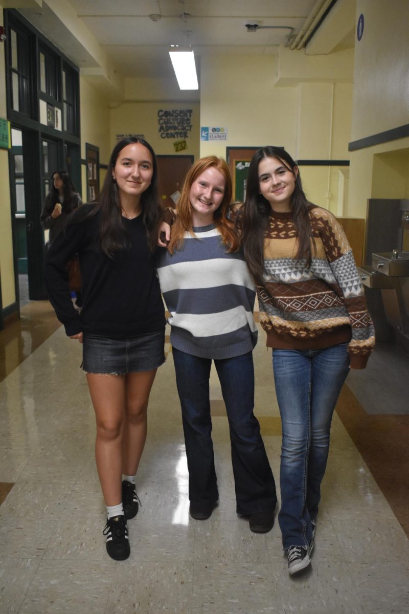 Claire Lavenue, Addison Clower, and Reagan Meyer wearing sweaters paired with denim.