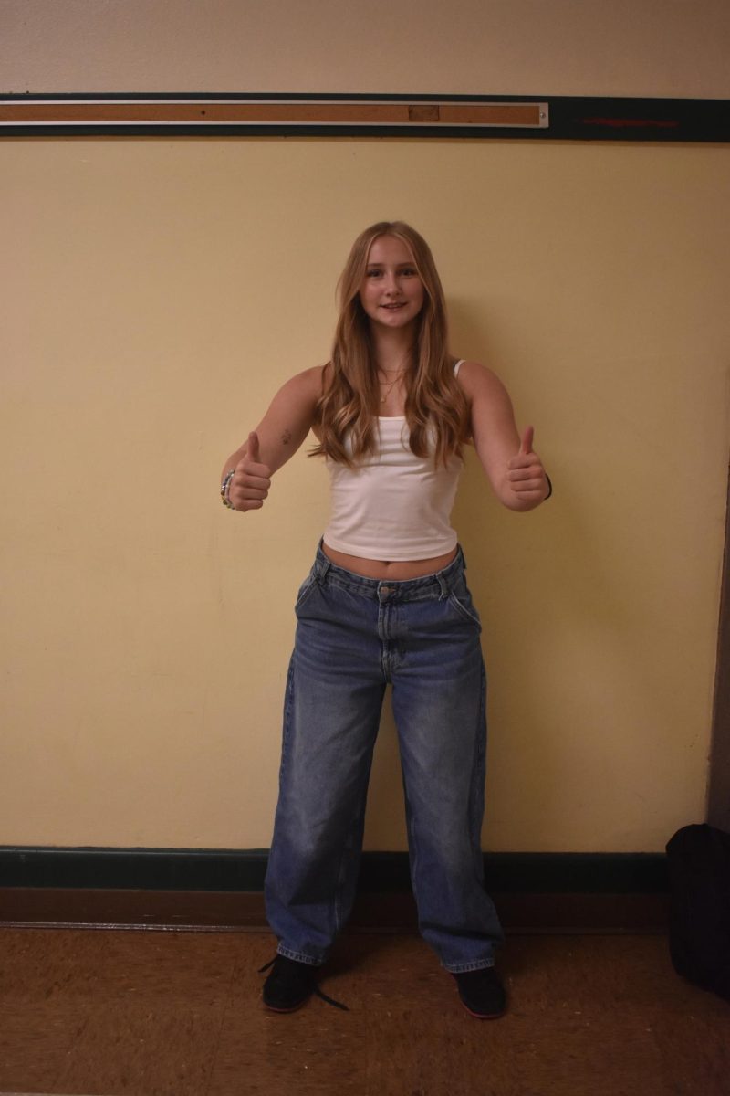 Lilly Love wearing baggy blue jeans paired with a white cropped tank.