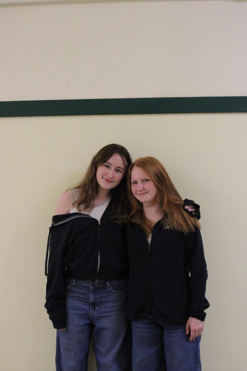 Lucy Sanders and Addison Clower twinning with blue jeans and black hoodies.