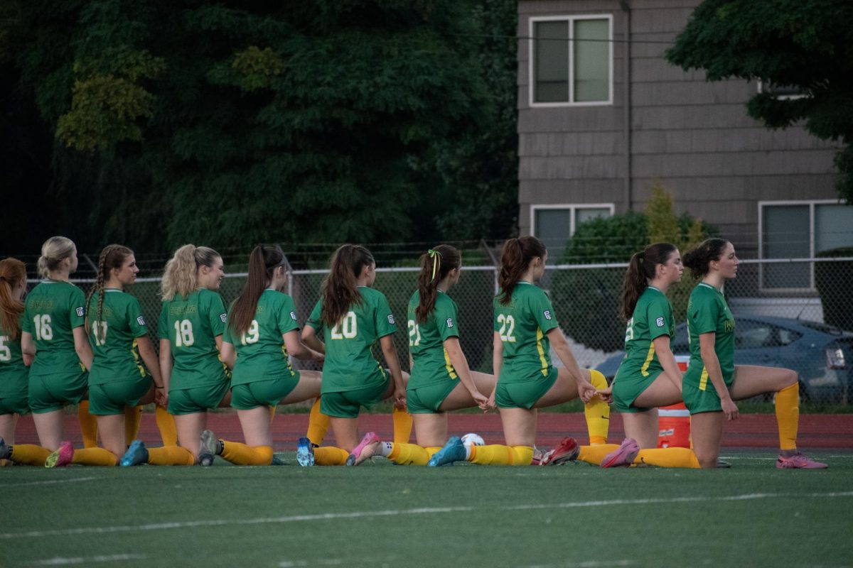The Girls Soccer team kneels during the national anthem in their home match against St. Mary's on Sept. 25. Livvy Betters Photo.