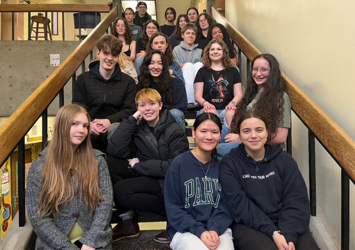 The Model UN participants sitting together on the stairs of the East Wing.