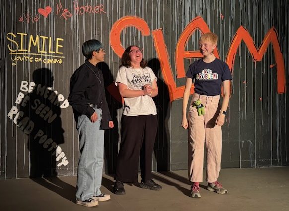 The three finalists, Fox Fox, Alida Shi Lyons, and Owl Matthews celebrating their victory on stage.