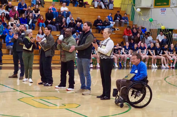 Hall of Fame Ceremony taking place in the gymnasium between Varsity Basketball games.