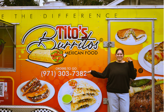 Tito's Worker, Alexandra, stands outside food pod.